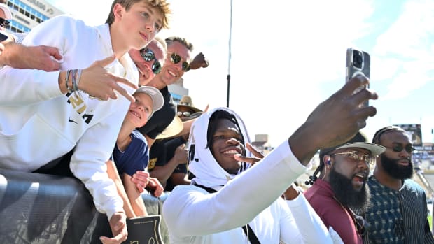 Sep 30, 2023; Boulder, Colorado, USA; Colorado Buffaloes cornerback Travis Hunter (12) takes selfies with fans after the game against the USC Trojans at Folsom Field. Mandatory Credit: John Leyba-USA TODAY Sports